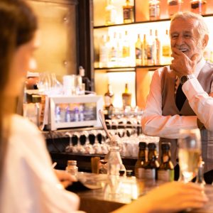 senior professional bartender making drink for business partner party relaxation, barkeeper working on bar with alcohol cocktail beverage at nightclub, drinking shaker mixer bar counter