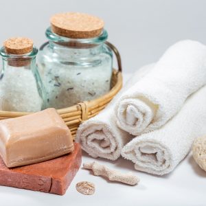 Spa and wellness setting with natural soap, sea salt and towel.