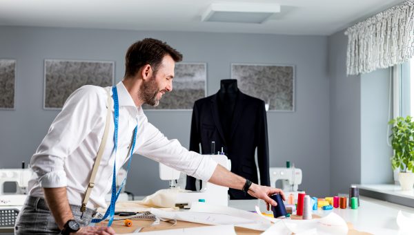 Tailor over work desk during work, fashion designer at workshop
