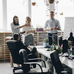 Staff meeting of a young successful team in the light modern office equipped with modern office equipment .